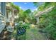 View of the backyard, with patio furniture and manicured landscape at 1712 Briarforest Pl, Raleigh, NC 27615