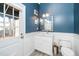 Well-lit bathroom with white vanity, marble countertop, and a classic white door with glass panels at 1712 Briarforest Pl, Raleigh, NC 27615