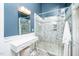 Elegant bathroom featuring a glass-enclosed shower and stylish vanity area with modern fixtures at 1712 Briarforest Pl, Raleigh, NC 27615