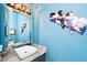 Stylish bathroom with a unique heart wall decor, a vessel sink, and a decorative mirror at 1712 Briarforest Pl, Raleigh, NC 27615