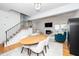 Open floorplan dining area with fireplace, wood floors, staircase, and an abundance of natural light at 1712 Briarforest Pl, Raleigh, NC 27615
