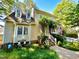 Inviting two-story house with charming landscaping, white picket fence, and classic architectural details at 1712 Briarforest Pl, Raleigh, NC 27615