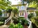 View of a two-story home with a white picket fence, mature trees and an American flag on display at 1712 Briarforest Pl, Raleigh, NC 27615