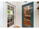 Hallway view of doors leading to screened porch and custom wine cellar at 1712 Briarforest Pl, Raleigh, NC 27615