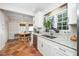 Bright kitchen featuring granite countertops, stainless appliances, and terracotta tile leading to a breakfast nook at 1712 Briarforest Pl, Raleigh, NC 27615