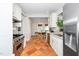 Bright kitchen with stainless steel appliances, granite countertops, terracotta tile, and breakfast nook at 1712 Briarforest Pl, Raleigh, NC 27615