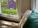 Sunlit window with garden view and accent pillows at 1712 Briarforest Pl, Raleigh, NC 27615