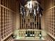 Intricate custom wine cellar with decorative chandelier at 1712 Briarforest Pl, Raleigh, NC 27615