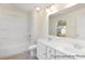 Bright bathroom featuring a double sink vanity, tub with shower, and large mirror at 187 Curling Creek Dr # 298P, Clayton, NC 27527