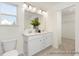 Well-lit bathroom featuring a double vanity, large mirror, and clean, modern fixtures at 187 Curling Creek Dr # 298P, Clayton, NC 27527