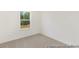 Bright bedroom with a large window and neutral carpeting, offering a serene and comfortable space at 187 Curling Creek Dr # 298P, Clayton, NC 27527