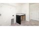Practical laundry room featuring a counter, storage shelves, and a clean, well-lit space at 187 Curling Creek Dr # 298P, Clayton, NC 27527