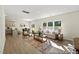 Bright living room features hardwood floors, comfortable seating, and natural light from large windows at 187 Curling Creek Dr # 298P, Clayton, NC 27527