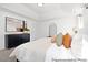 Bright primary bedroom with a king-sized bed, dark dresser and views into the primary bath at 197 Curling Creek Dr # 299P, Clayton, NC 27527