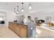Spacious kitchen with a large island, wood drawers, modern lighting, and an open layout leading to the living area at 197 Curling Creek Dr # 299P, Clayton, NC 27527