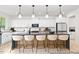 Modern kitchen with stylish pendant lighting, a large island with bar stools, and sleek white cabinetry at 197 Curling Creek Dr # 299P, Clayton, NC 27527