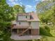 Back of home featuring a large deck with stairs and a spacious yard at 200 Weybossett Rd, Henderson, NC 27537