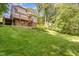 Expansive backyard featuring a deck, stairs, and lush green grass at 200 Weybossett Rd, Henderson, NC 27537