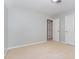 A bedroom with light-colored walls, carpet, and two closets providing space for storage at 200 Weybossett Rd, Henderson, NC 27537