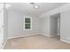 Simple bedroom with a window, neutral paint, and light carpeting, providing a blank canvas at 200 Weybossett Rd, Henderson, NC 27537