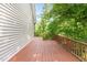 Exterior deck with stained wood, railing, and view of surrounding woods at 200 Weybossett Rd, Henderson, NC 27537