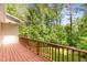 Exterior deck with stained wood, railing, and view of surrounding woods at 200 Weybossett Rd, Henderson, NC 27537