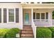 Inviting front porch with brick steps and a turquoise front door at 200 Weybossett Rd, Henderson, NC 27537