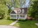 Charming home with manicured front lawn and inviting front porch in a serene, wooded setting at 200 Weybossett Rd, Henderson, NC 27537