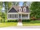 Charming home with manicured front lawn and inviting front porch in a serene, wooded setting at 200 Weybossett Rd, Henderson, NC 27537