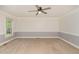 Bright, carpeted living room with neutral paint, a ceiling fan, and natural light from a window at 200 Weybossett Rd, Henderson, NC 27537