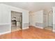 Open living room with hardwood floors leading to the kitchen, with white cabinets and stainless steel appliances at 200 Weybossett Rd, Henderson, NC 27537