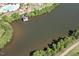 Aerial view of lake with a boathouse surrounded by lush greenery at 201 Annabelle Blue Drive, Wake Forest, NC 27587