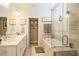 Elegant bathroom with a dual-sink vanity, soaking tub, and glass-enclosed shower for a spa-like experience at 201 Annabelle Blue Drive, Wake Forest, NC 27587