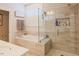 Luxurious bathroom featuring a soaking tub and walk-in shower with elegant tile and modern fixtures at 201 Annabelle Blue Drive, Wake Forest, NC 27587