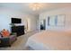 Spacious bedroom with soft carpet, comfortable chair, TV, and an elegant mirror at 201 Annabelle Blue Drive, Wake Forest, NC 27587