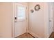 Bright entryway features a white front door, decorative floral accents, and welcoming ambiance at 201 Annabelle Blue Drive, Wake Forest, NC 27587