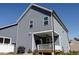 Rear exterior view of a two-story home featuring a covered porch and an outdoor kitchen at 201 Annabelle Blue Drive, Wake Forest, NC 27587