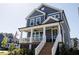 Two-story home featuring a welcoming front porch, stairs, and landscaped front yard at 201 Annabelle Blue Drive, Wake Forest, NC 27587
