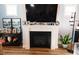 Inviting living room boasts a fireplace with decorative mantle, complemented by modern decor and hardwood floors at 201 Annabelle Blue Drive, Wake Forest, NC 27587