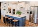 Modern kitchen with a large island, white cabinets, and stainless steel appliances at 201 Annabelle Blue Drive, Wake Forest, NC 27587