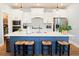 Stylish kitchen with a spacious island, modern appliances, and convenient pantry access at 201 Annabelle Blue Drive, Wake Forest, NC 27587