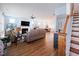 Bright, open-concept living room with hardwood floors, fireplace, and seamless flow to the dining area at 201 Annabelle Blue Drive, Wake Forest, NC 27587