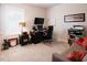 Well-lit office with desk, computer, wall-mounted TV, and comfortable seating in a carpeted room at 201 Annabelle Blue Drive, Wake Forest, NC 27587