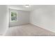 Inviting bedroom with plush carpeting and large window at 207 Curling Creek Dr # 300P, Clayton, NC 27527