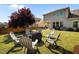 Large backyard featuring comfortable seating areas, a fire pit, beautiful trees, and green lawn at 212 Crisp Rd, Durham, NC 27713