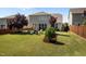 Large backyard with green space, play area, mature trees, a patio, and comfortable outdoor seating at 212 Crisp Rd, Durham, NC 27713