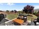 Spacious backyard with a patio, seating area, large lawn, and mature trees at 212 Crisp Rd, Durham, NC 27713