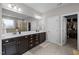 Primary bathroom boasts a dual sink vanity, framed mirrors, and access to a walk-in closet at 212 Crisp Rd, Durham, NC 27713
