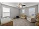 Bright Bedroom with a crib, changing table, chair, and plenty of natural light from the windows at 212 Crisp Rd, Durham, NC 27713