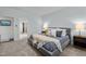 Well-lit bedroom with neutral walls, bedside tables, plush carpet, and a comfortably styled bed at 212 Crisp Rd, Durham, NC 27713